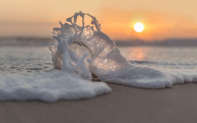 Strand, golven, zonsondergang Noordwijk