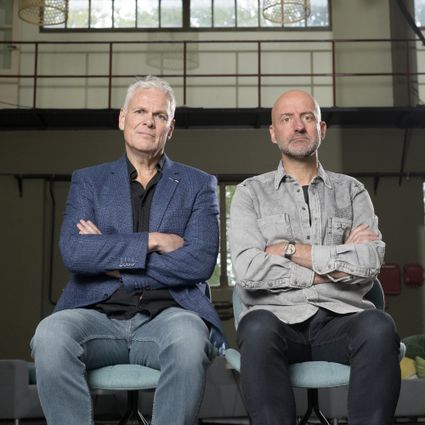 Foto van Joep en Rob, naast elkaar zittend op een stoel met de armen over elkaar.