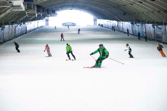 Een groep mensen is aan het skiën in de skihal.