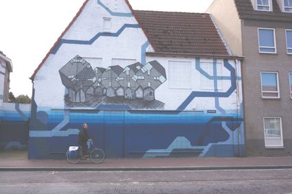 Streetart in de Heistraat in Helmond. De iconische kubuswoningen.