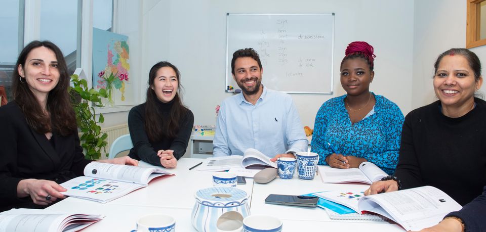 people smiling with their language textbooks