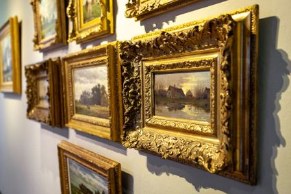 Instaprondleiding in het Stadsmuseum Woerden met een detail van ingelijste schilderijen in een museumzaal.
