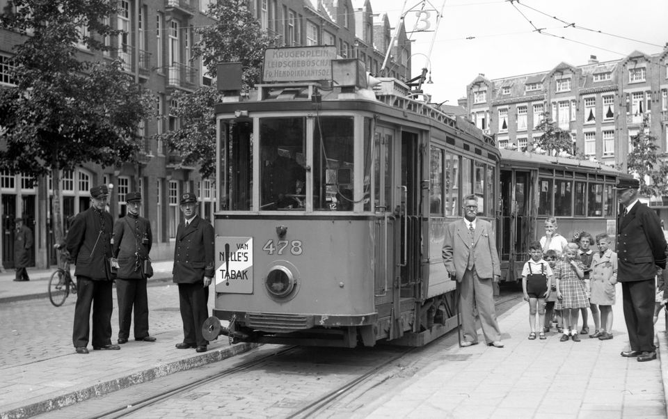 Een zwart-wit foto van een tram met mensen