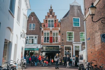 Busy shopping street with classical houses.