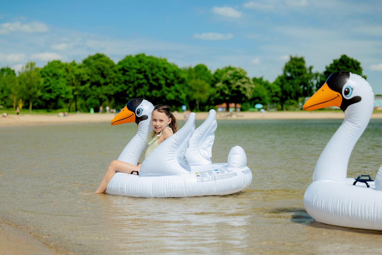 Meisje in zwemband in het water.