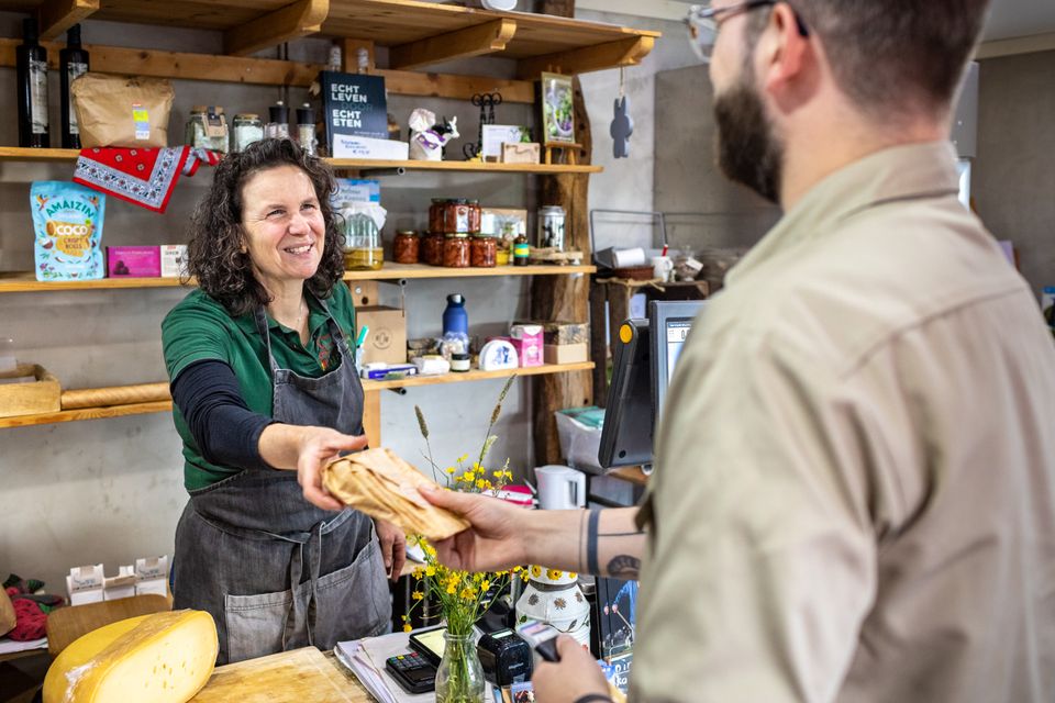 Een klant rekent af bij de boerderijwinkel van De Beekhoeve in Kamerik, met een aanbod van verse streekproducten, onderdeel van Hollandse Ambachten Utrecht Region.