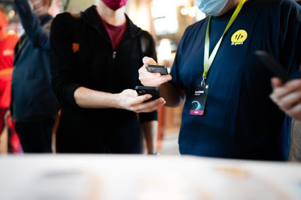 Person scanning vaccination QR code.