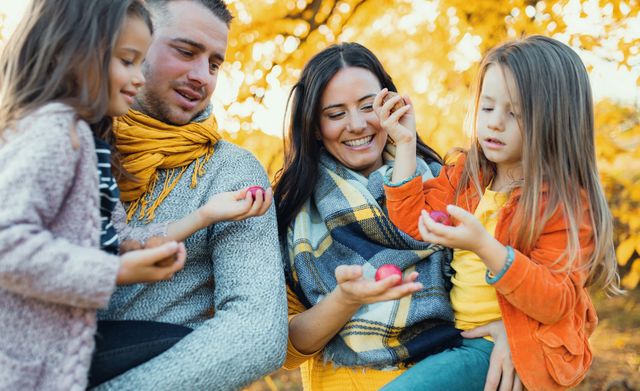 Familie bewondert een appel- en walnoten oogst in de herfst