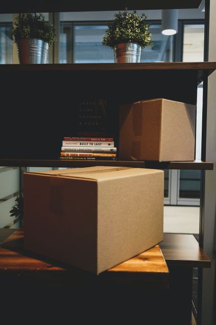 Packed boxes and a bookshelf.