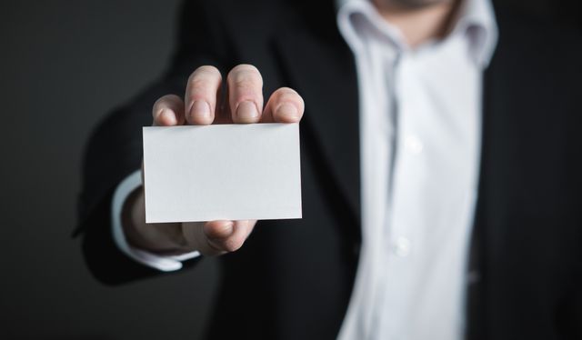Person showing business card.