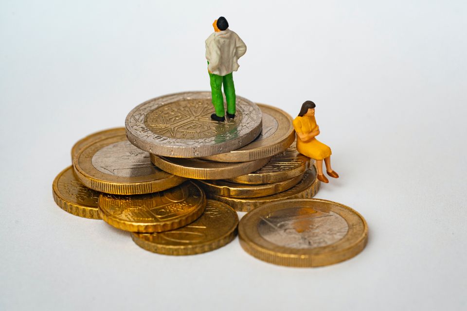 Puppets standing on money
