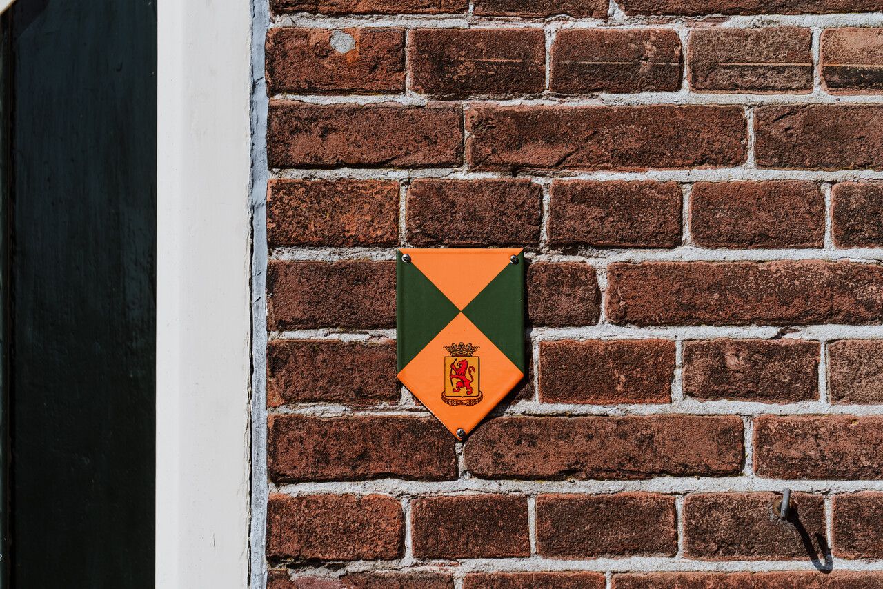 Monument schildje op een huisnijverheidshuisje.