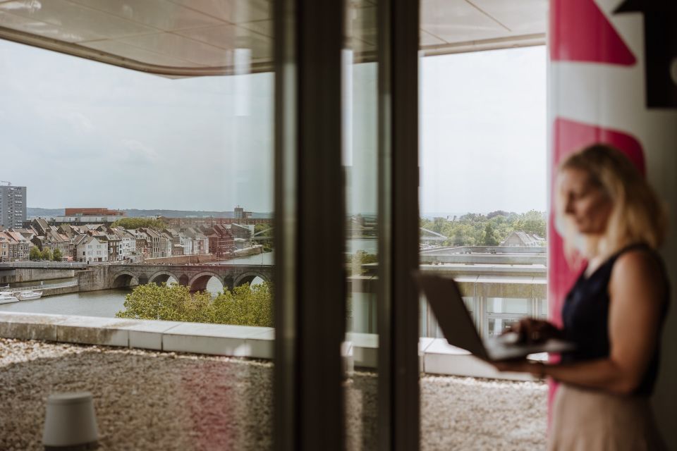 Georgina with her laptop, looking out over Maastricht