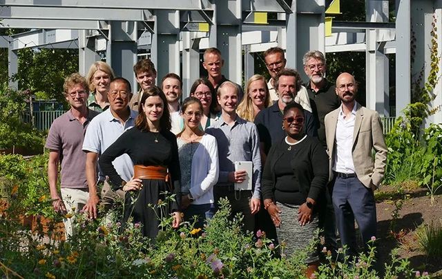 A group of people smiling and posing for the camera.