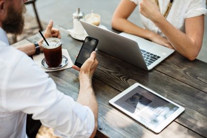 Two people using various devices.