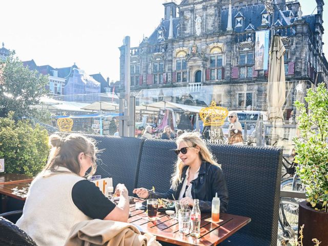 Twee vrouwen aan het lunchen op het terras van 't koningshuys in de herfst