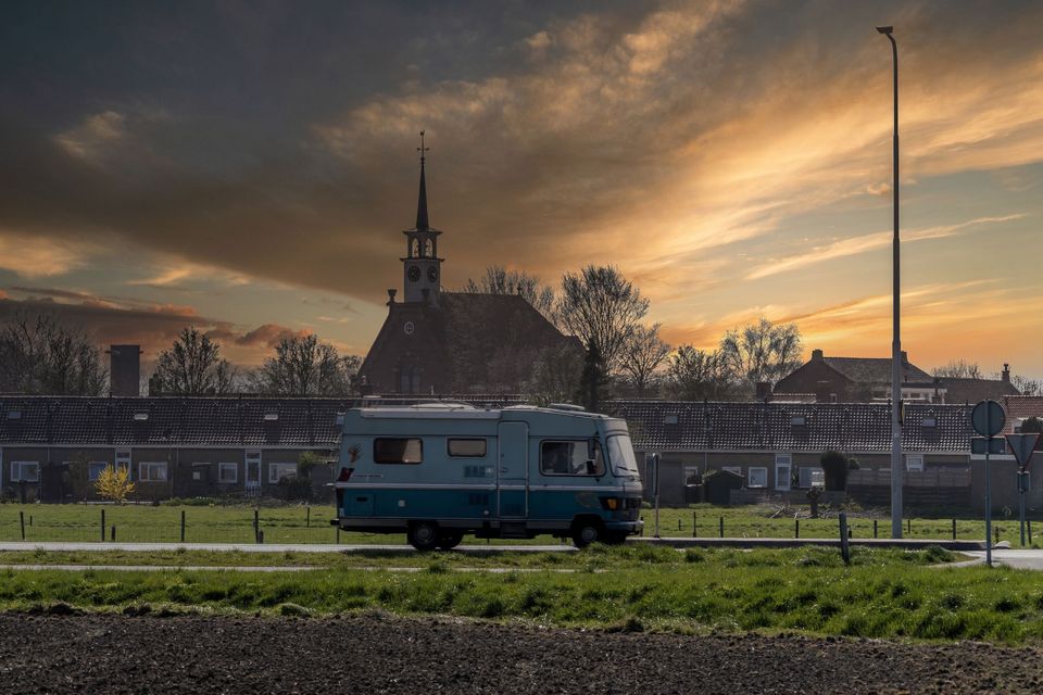 Op-Schouwen-Duiveland-Kerkwerve-Stormachtige-Dag-Met-Zonsondergang-Met-Camper-Voor-Het-Dorp