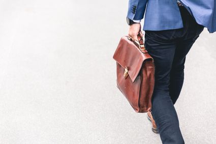 Person walking with briefcase.