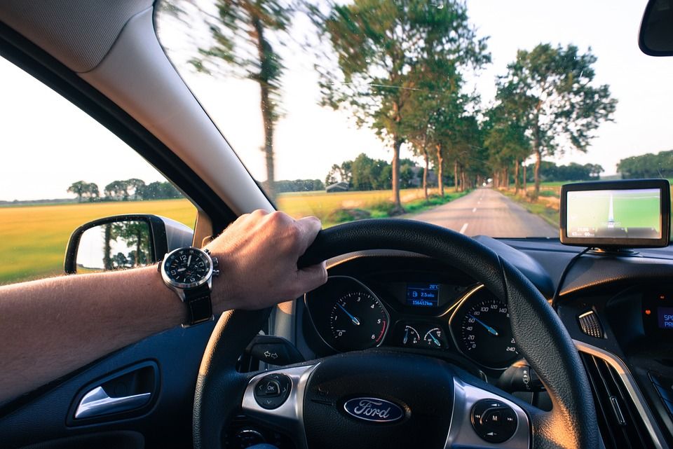 Driving a car.
