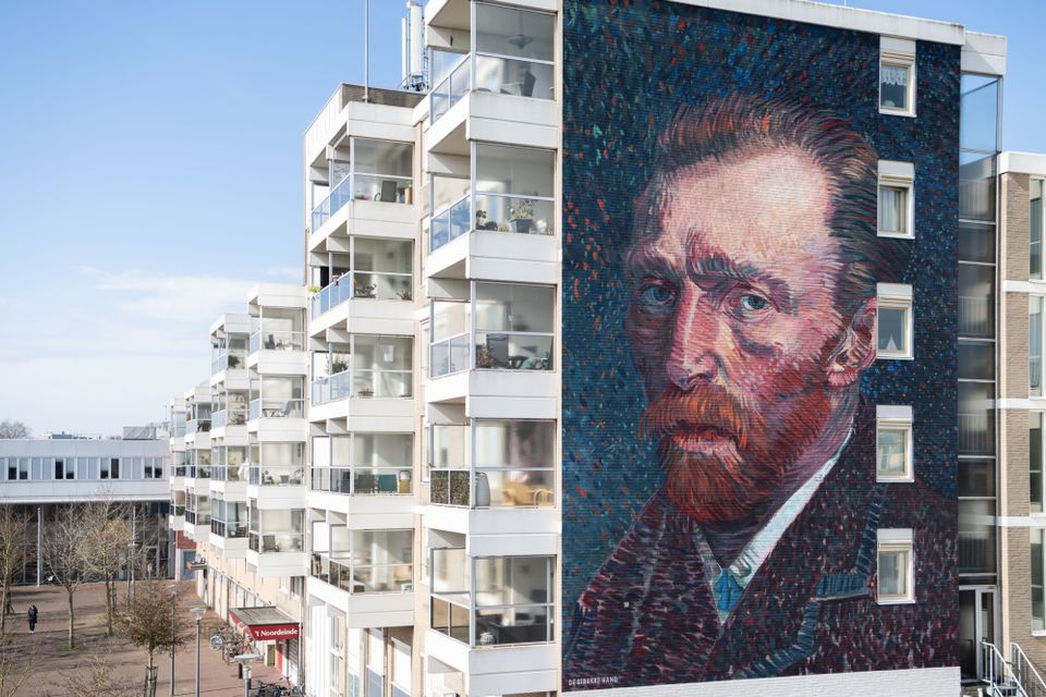 Een huizenhoge muurschildering van het gezicht van Vincent van Gogh prijkt aan de zijkant van een flat in Hoogeveen.