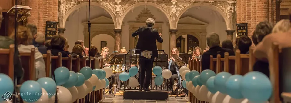 Een kerk vol met mensen en balonnen