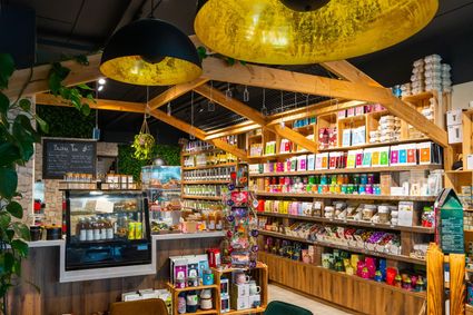 Speciaalzaak Amiza Tea Boutique Woerden, provincie Utrecht, Groene Hart, blikjes met losse thee en kaarten met ijsthee recepten op houten tafel in de theewinkel in het centrum.