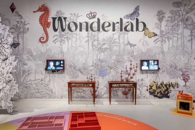 Twee schermen aan een muur waar heel groot 'Wonderlab' opstaat