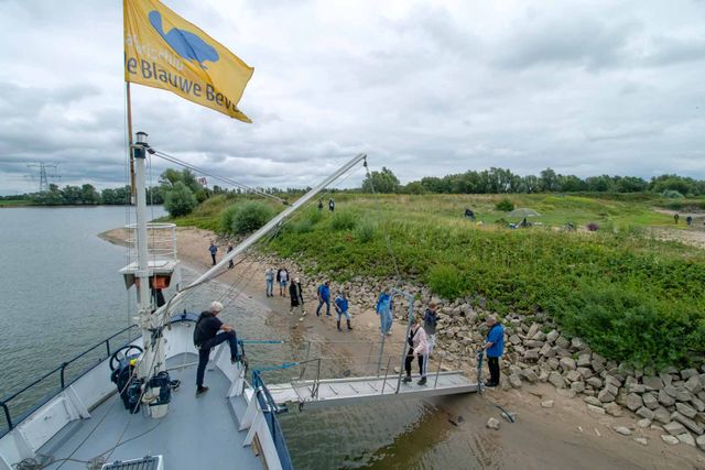 Passagiers gaan verlaten het schip voor wandelexcursie in de Loowaard bij Huissen.