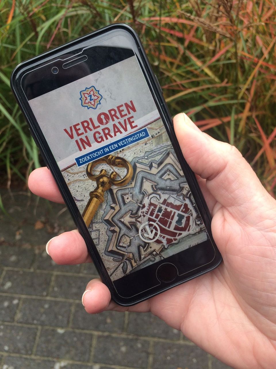 Een telefoon met de app waarmee je de city game in Grave kunt spelen.