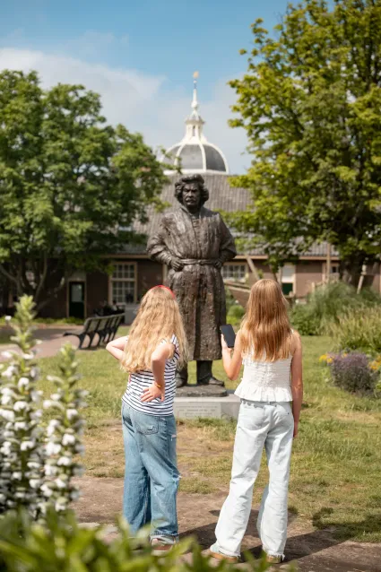 Girls in front of statue