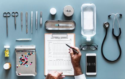 Image of a doctors daily report schedule and medical related tools