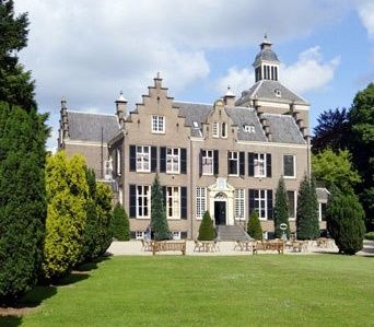 Het vooraanzicht van het Maarten Maartenshuis op Landgoed Zonheuvel onder een blauwe lucht