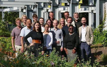 A group of people smiling and posing for the camera.