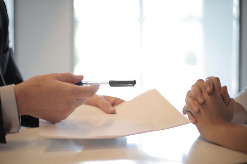 Two people speaking over a document.