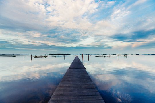 Een lange stijger op het water die uitkijkt over het water in de Noordoostpolder.
