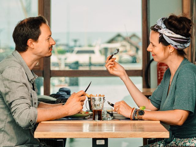 Man en vrouw aan het dineren in restaurant in haven.