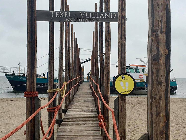 Via een houten brug op het strand bereik je de pont