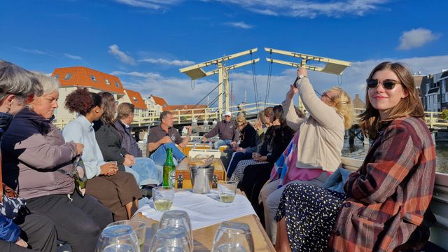 people sitting in a boat having a tour