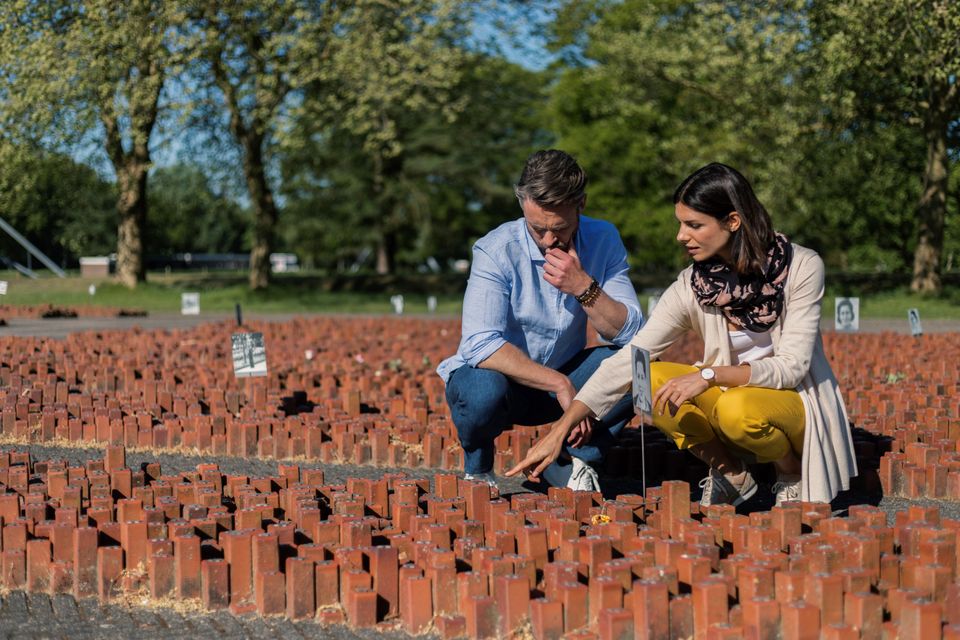 Ein Paar beobachtet das Denkmal mit den 102.000 Steinen zur Erinnerung an die 102.000 Juden und Roma, die von hier deportiert wurden.
