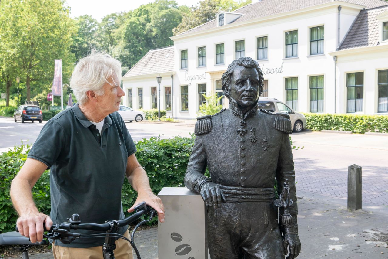 Man die kijkt naar het standbeeld van Generaal Johannes van den Bosch. Op de achtergrond het monumentale Hotel Frederiksoord.