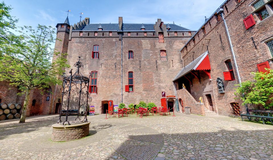 Historische binnenplaats van Kasteel Muiderslot met klinkers en waterput