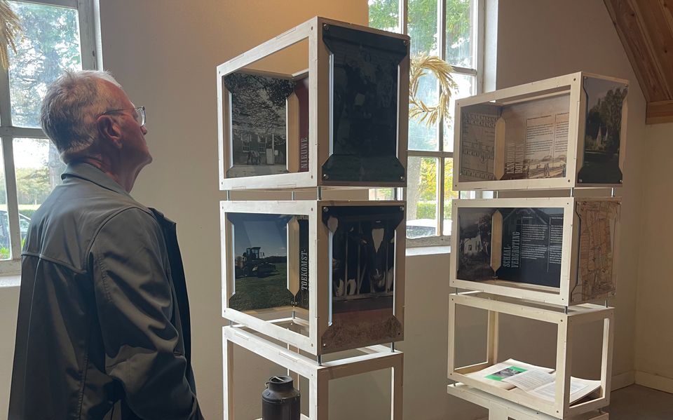 Man die de expositie bij Hoeve Koning Willem III bekijkt