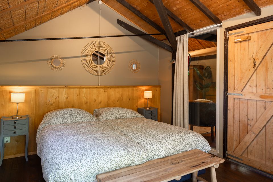 Een slaapkamer van Vakantieboerderij Landelijk Genieten