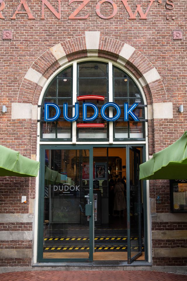 Een gastvrije entree naar ons restaurant, gekenmerkt door een groot bakstenen gebouw dat extra karakter toevoegt aan de eetervaring.