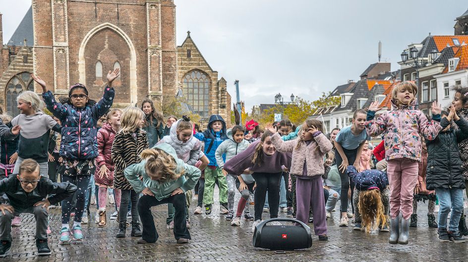 Groep dansende kinderen op het Marktplein in Delft tijdens Cultuurbarbaren 2022
