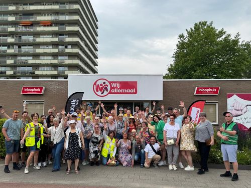 Een grote groep wandelaars voor een gebouw
