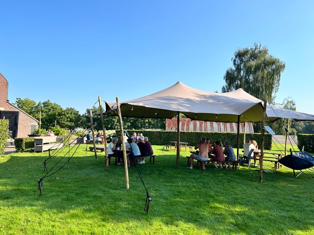 Mensen zitten onder een tent bij Slapen bij Herman