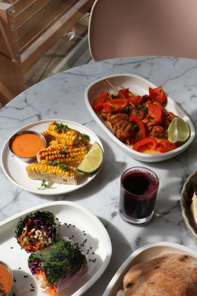 Colourful shared-dining dishes and fresh juice to enjoy together at Well in Breda.