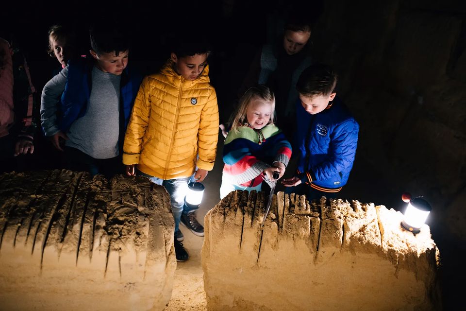 Maastricht caves children try out saw