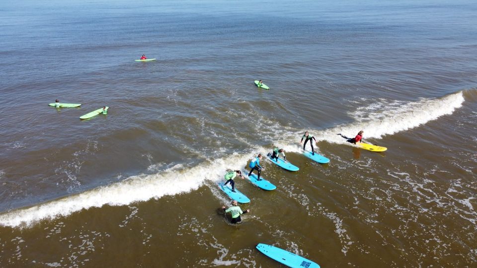 Kinderen leren surfen in de Noordzee bij Beachbreak